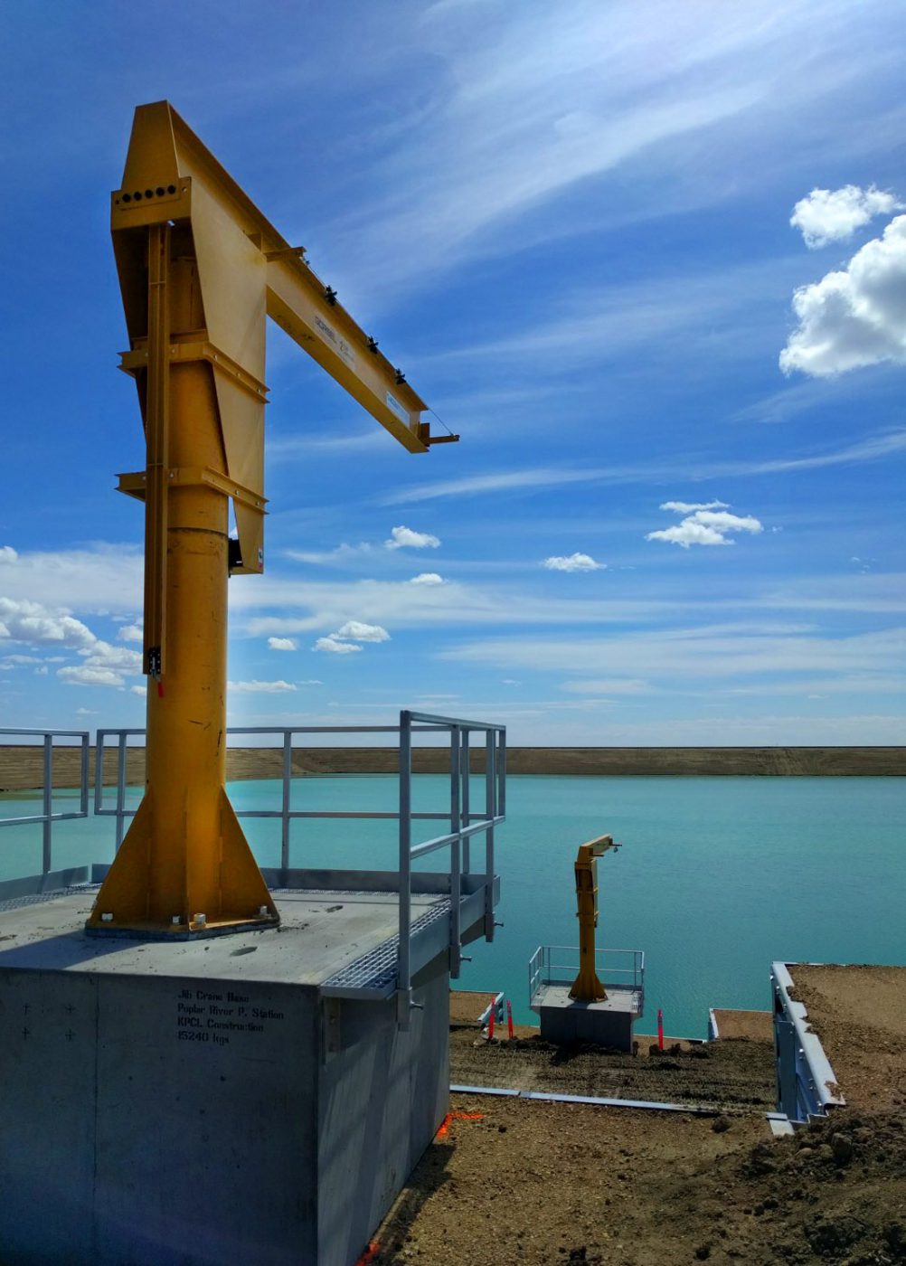 Beautiful shot of an outdoor Gorbel jib cranes in front of a retention pond.