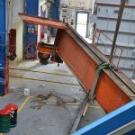 aerial view straps removing a heavy crane from a building