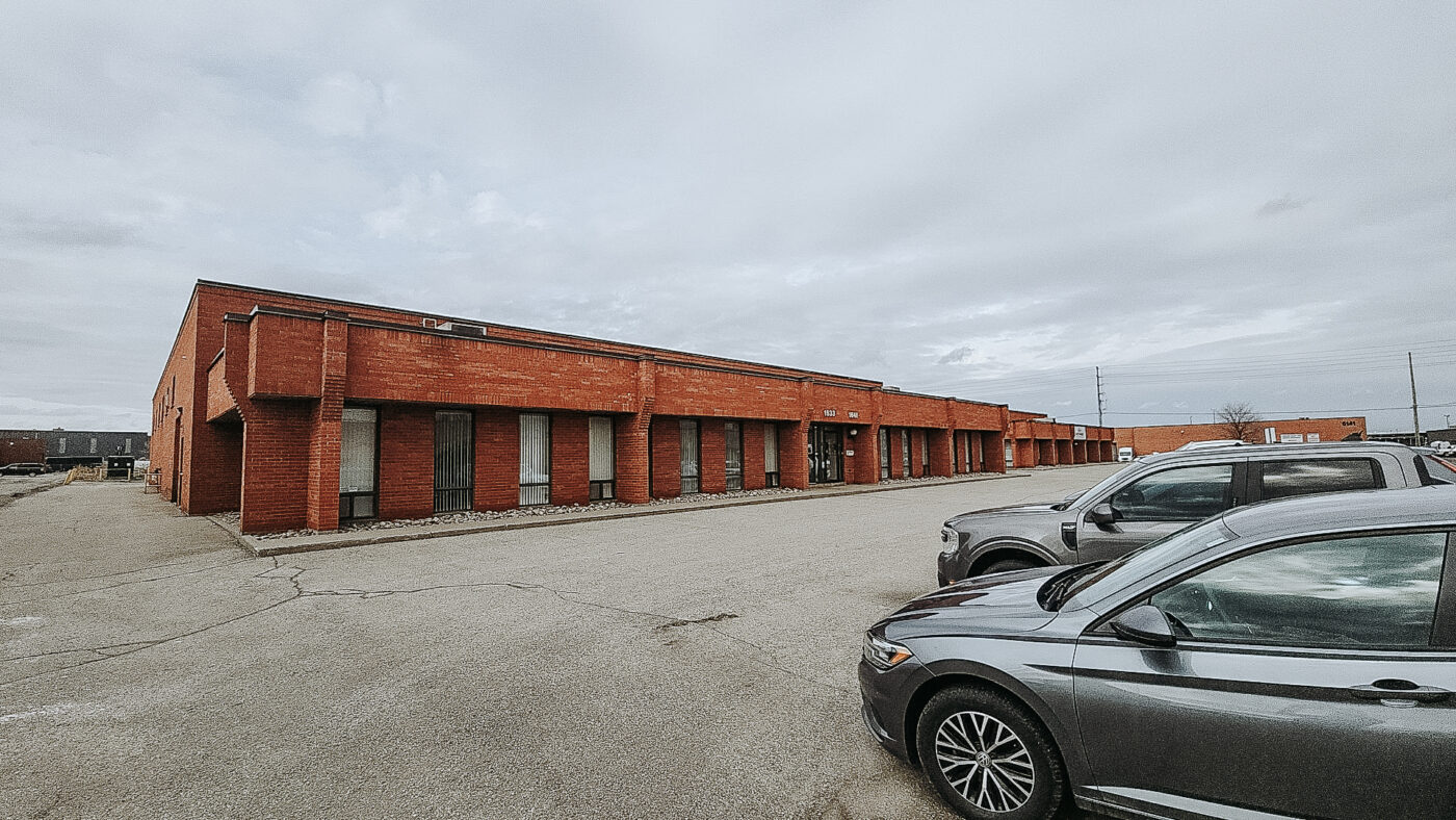 Wide view of Acculift’s Mississauga facility showing industrial building and parking area