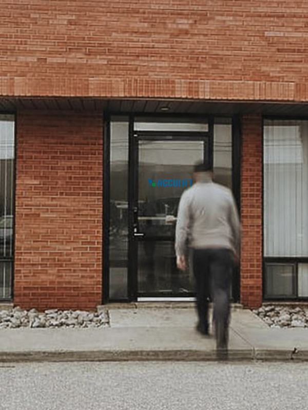 Acculift Mississauga location exterior with team members walking toward the building entrance