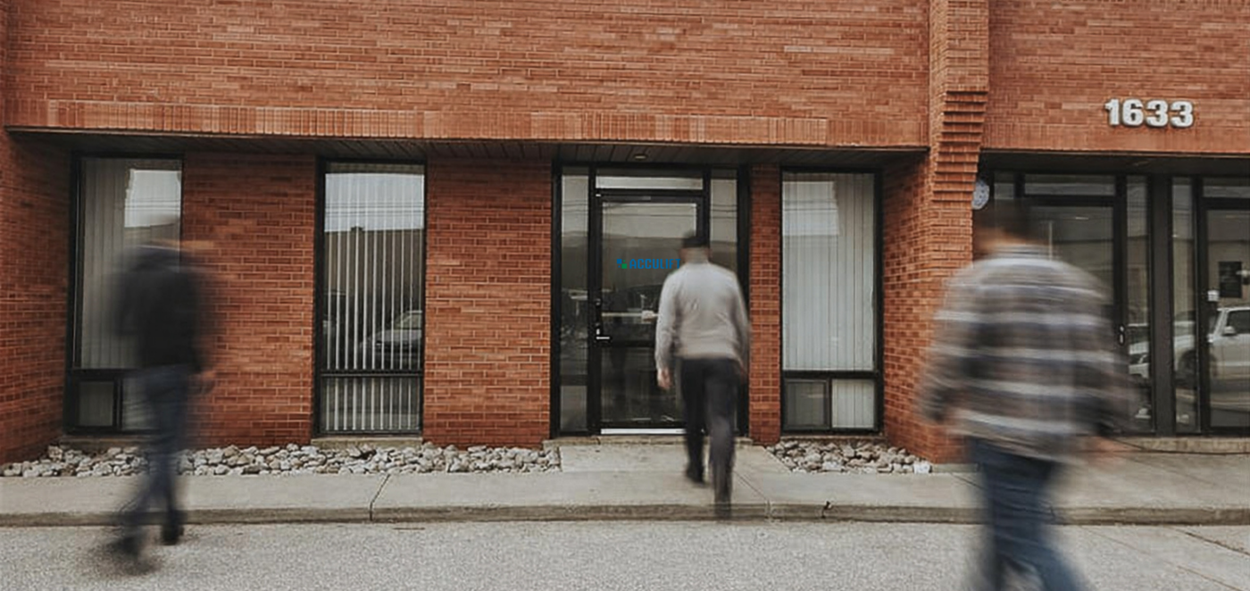Acculift Mississauga location exterior with team members walking toward the building entrance